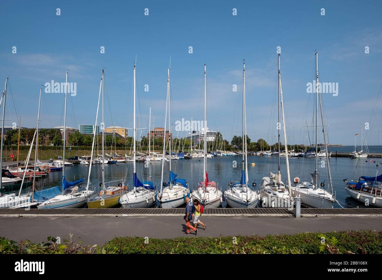 People walking by sailboats in Langelinie yacht harbour, Copenhagen, Denmark, Europe Stock Photo