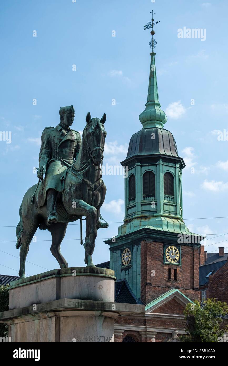 King Christian X equestrian statue in front of the Garrison church tower in Copenhagen, Denmark, Europe Stock Photo