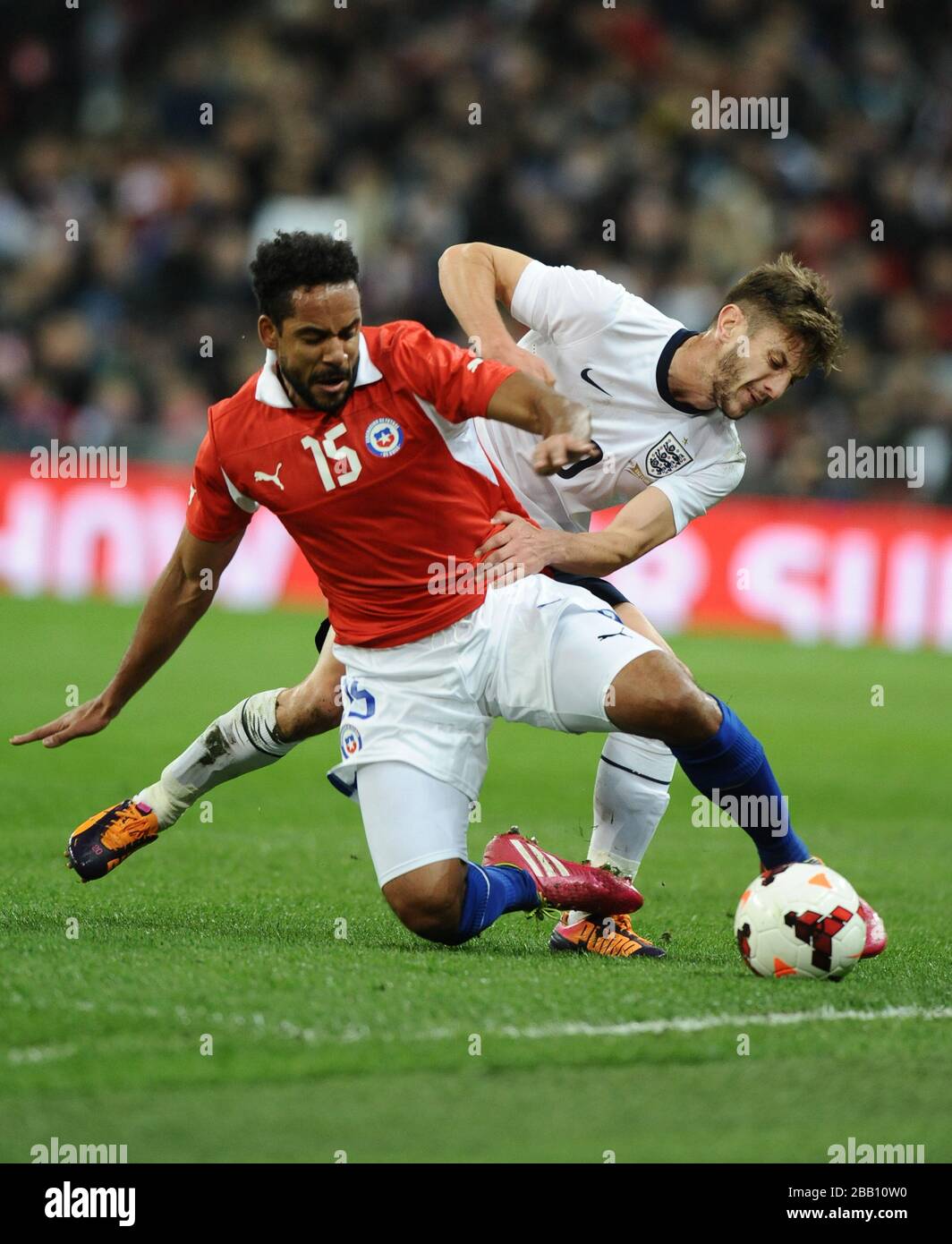 England's Adam Lallana (right) tackles Chile's Jean Beausejour (left) Stock Photo