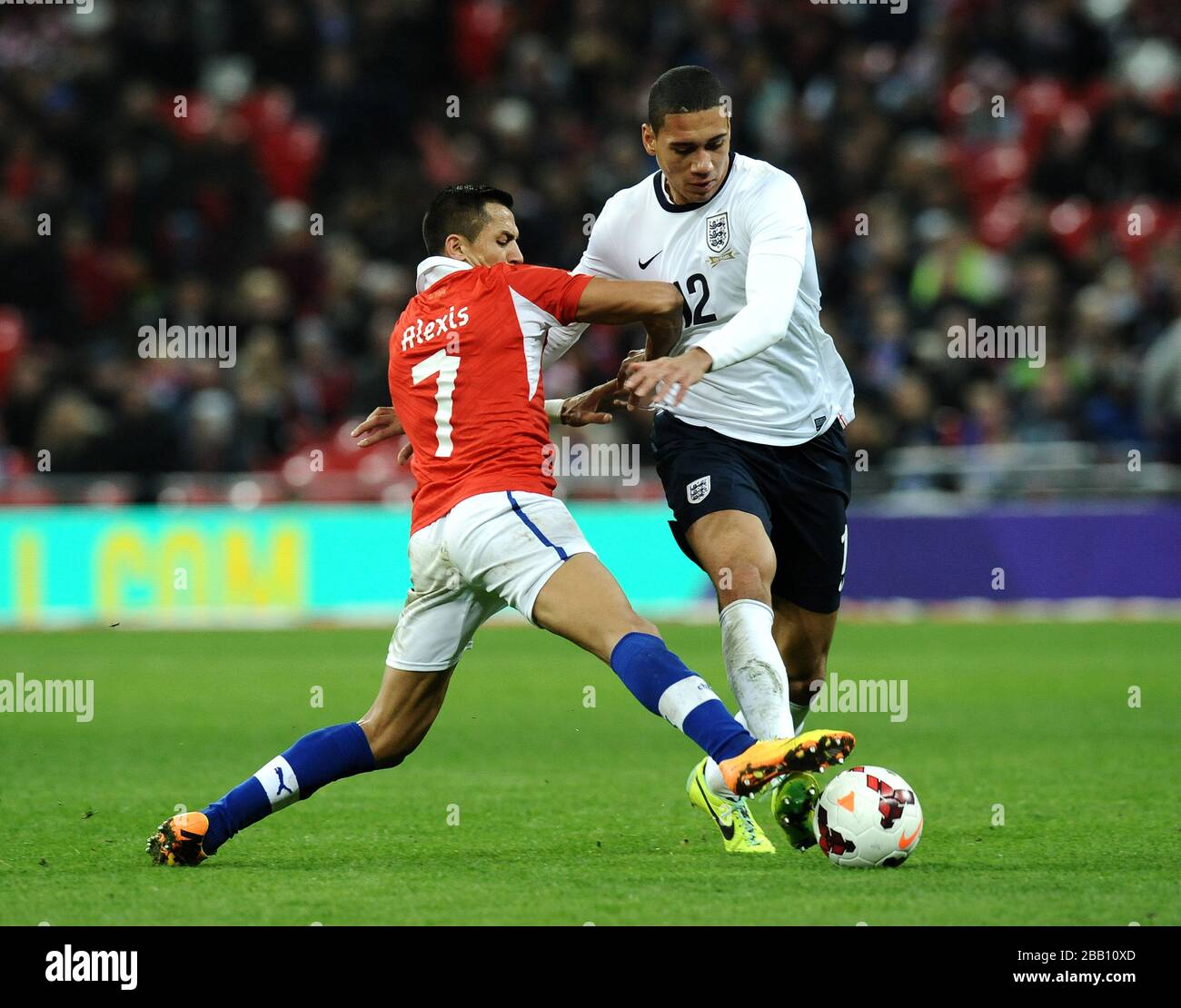 England's Chris Smalling tackled by Chile's Alexis Sanchez Stock Photo