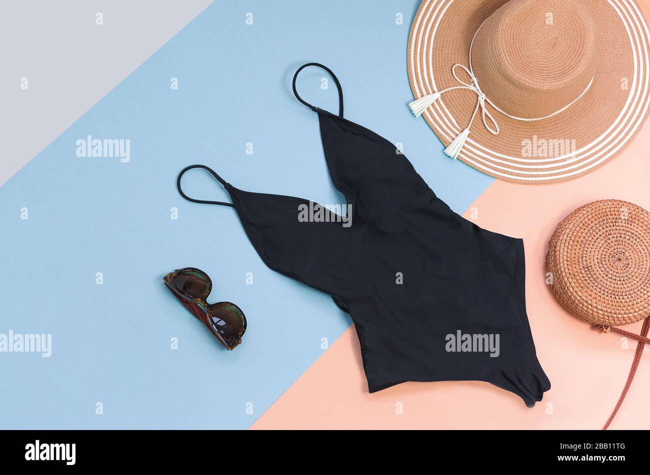 Swimming suit with sunglasses and straw hat for summer. Flatlay Stock Photo