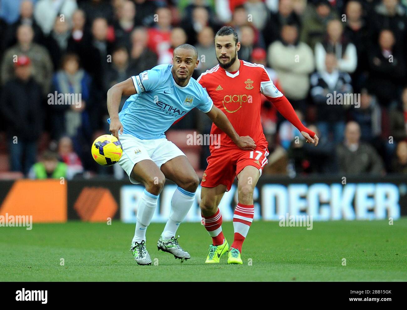 Manchester City's Vincent Kompany (left) and Southampton's Pablo Daniel Osvaldo battle for the ball Stock Photo
