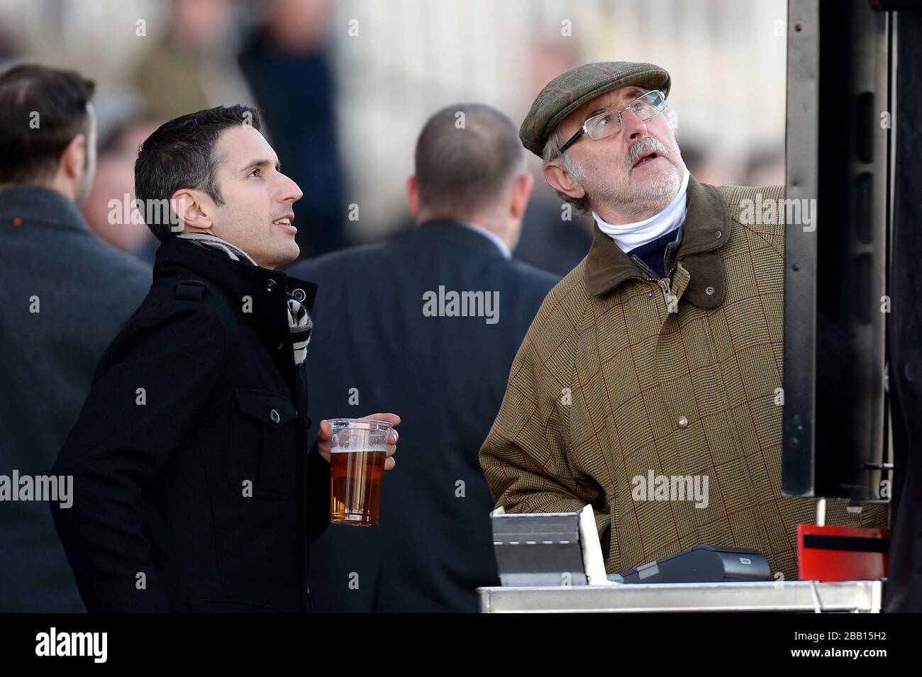 Racegoers place bets during the Tingle Creek Christmas Festival at Sandown Racecourse Stock Photo