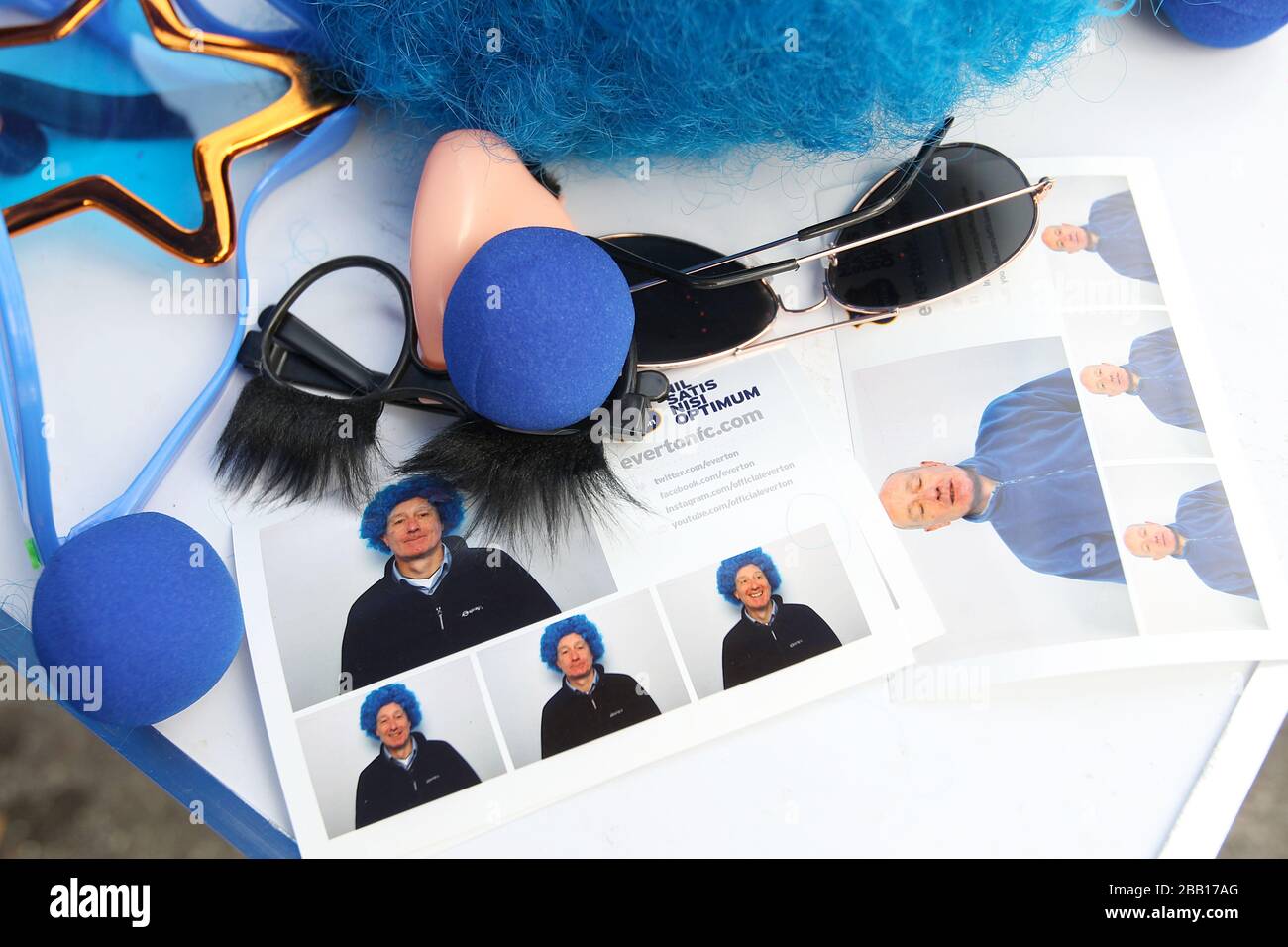 Everton blue noses a wig and comedy glasses are seen in the Fan Zone outside Goodison Park Stock Photo