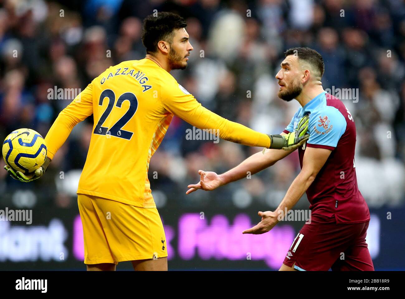 West Ham United's Robert Snodgrass (right) attempts to get the ball off of Tottenham Hotspur goalkeeper Paulo Gazzaniga Stock Photo