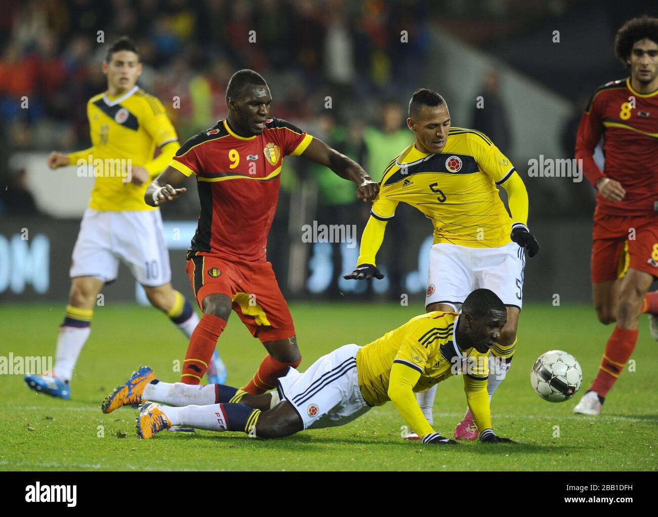 Colombia's  Cristian Zapata (floor) and Aldo Leao Ramirez (no5) stop Belgium's Christian Benteke (no9) battle for the ball. Stock Photo
