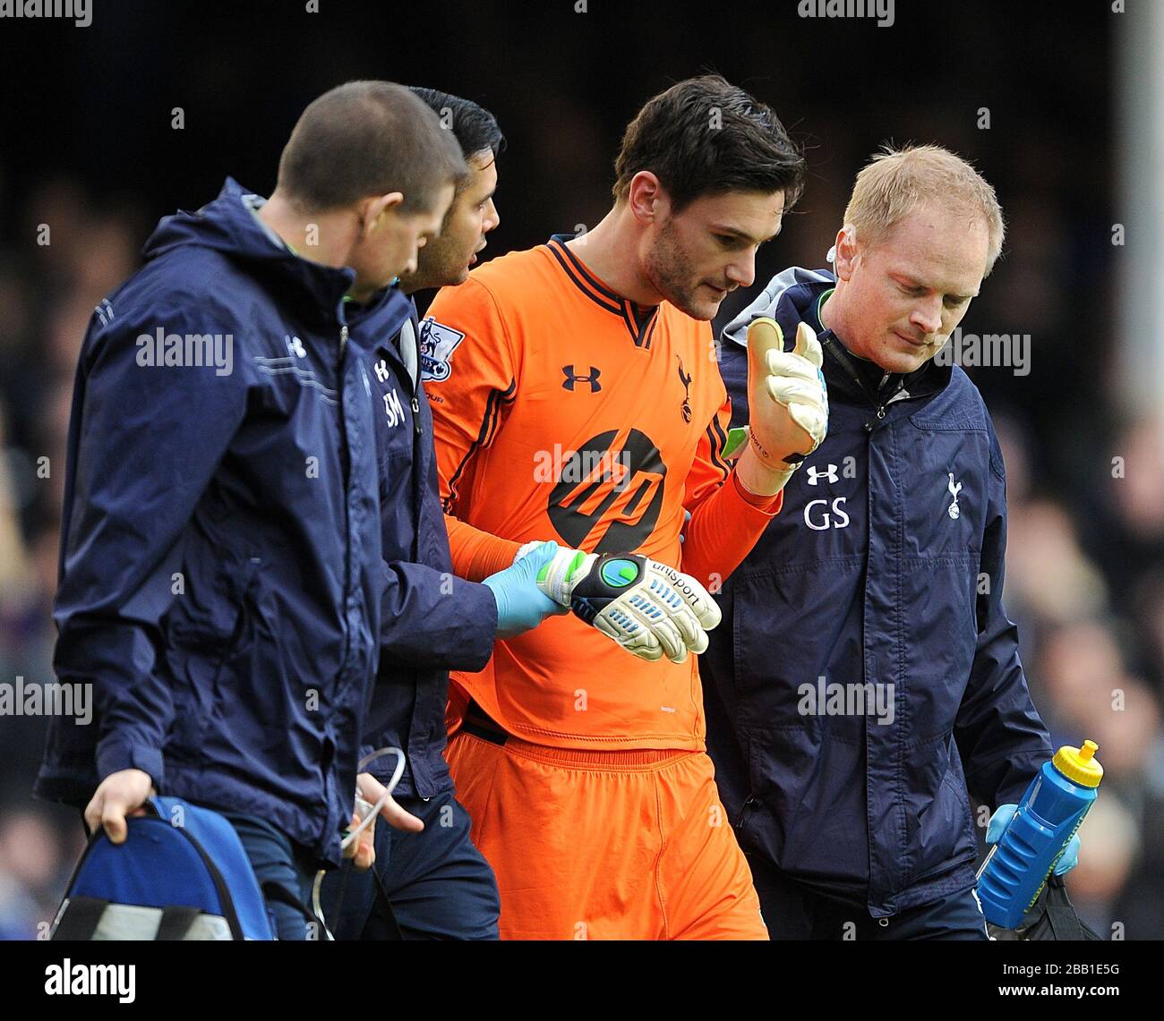 Tottenham Hotspur goalkeeper Hugo Lloris is escorted off the pitch after a collission with Everton's Romelu Lukaku (not in picture) Stock Photo