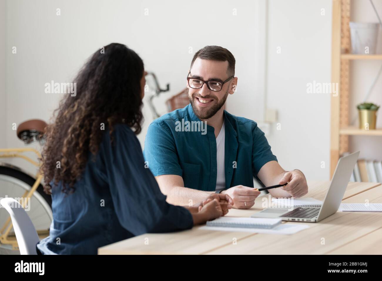Smiling diverse colleagues laugh brainstorming at meeting Stock Photo ...