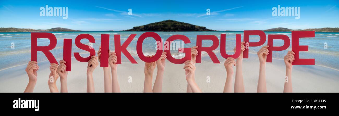 People Hands Holding Word Risikogruppe Means High-Risk Group, Ocean Background Stock Photo