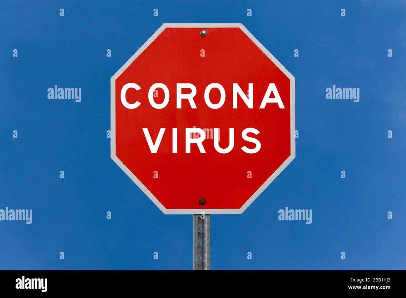 Corona virus warning sign with clear blue sky background Stock Photo