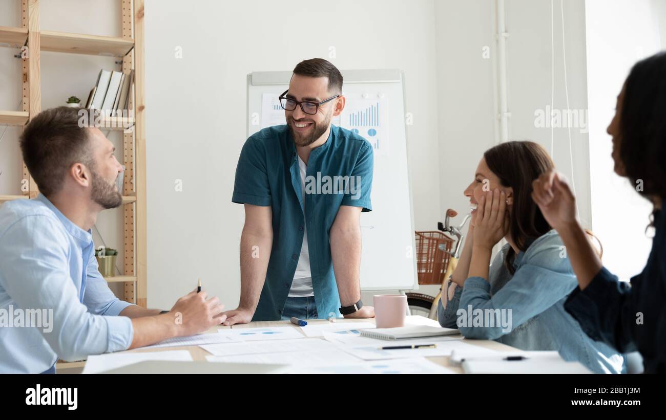 Happy diverse colleagues have fun brainstorming at meeting Stock Photo ...