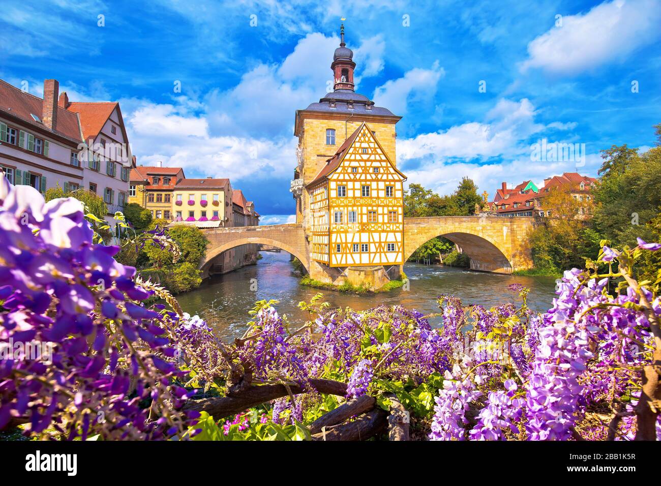 Scenic view of Old Town Hall of Bamberg (Altes Rathaus) with two bridges over the Regnitz river flower view,  Upper Franconia, Bavaria region of Germa Stock Photo