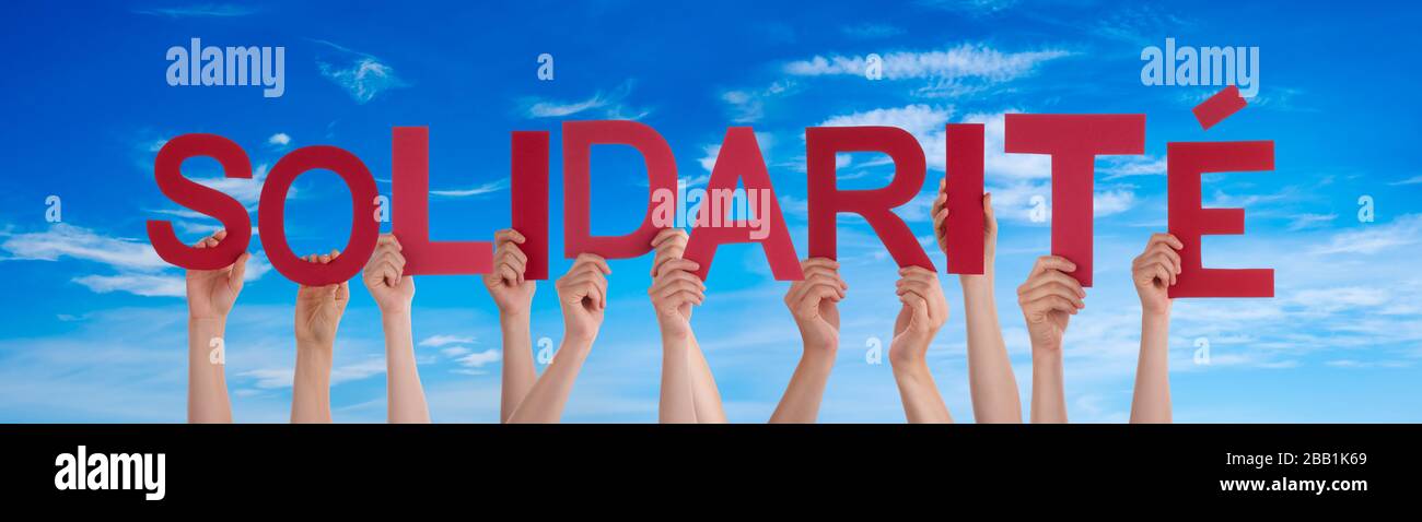 People Hands Holding Word Solidarite Means Solidarity, Blue Sky Stock Photo