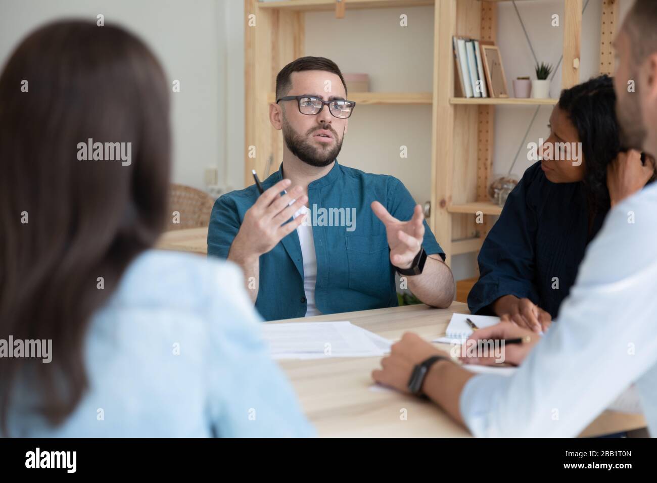 Concentrated multiracial colleagues brainstorm at office meeting Stock ...