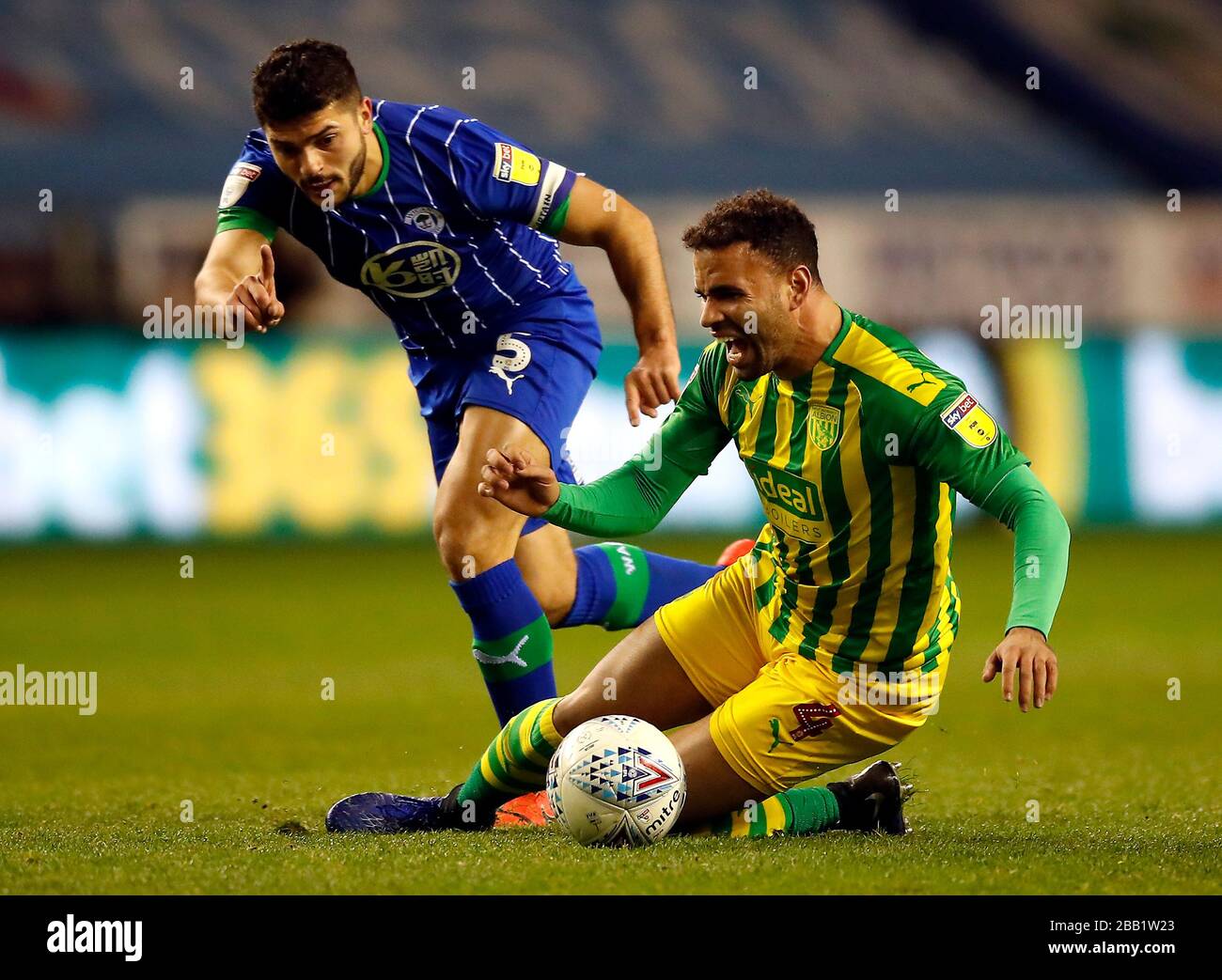 Wigan Athletic's Sam Morsy (left) and West Bromwich Albion's Hal Robson-Kanu battle for the ball during the Sky Bet Championship match at the DW Stadium, Wigan. PA Photo. Picture date: Wednesday December 11, 2019. See PA story SOCCER Swansea. Photo credit should read: Martin Rickett/PA Wire. RESTRICTIONS: EDITORIAL USE ONLY No use with unauthorised audio, video, data, fixture lists, club/league logos or 'live' services. Online in-match use limited to 120 images, no video emulation. No use in betting, games or single club/league/player publications. Stock Photo