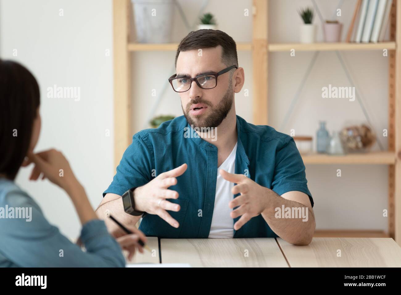 Confident male candidate talk at office interview Stock Photo