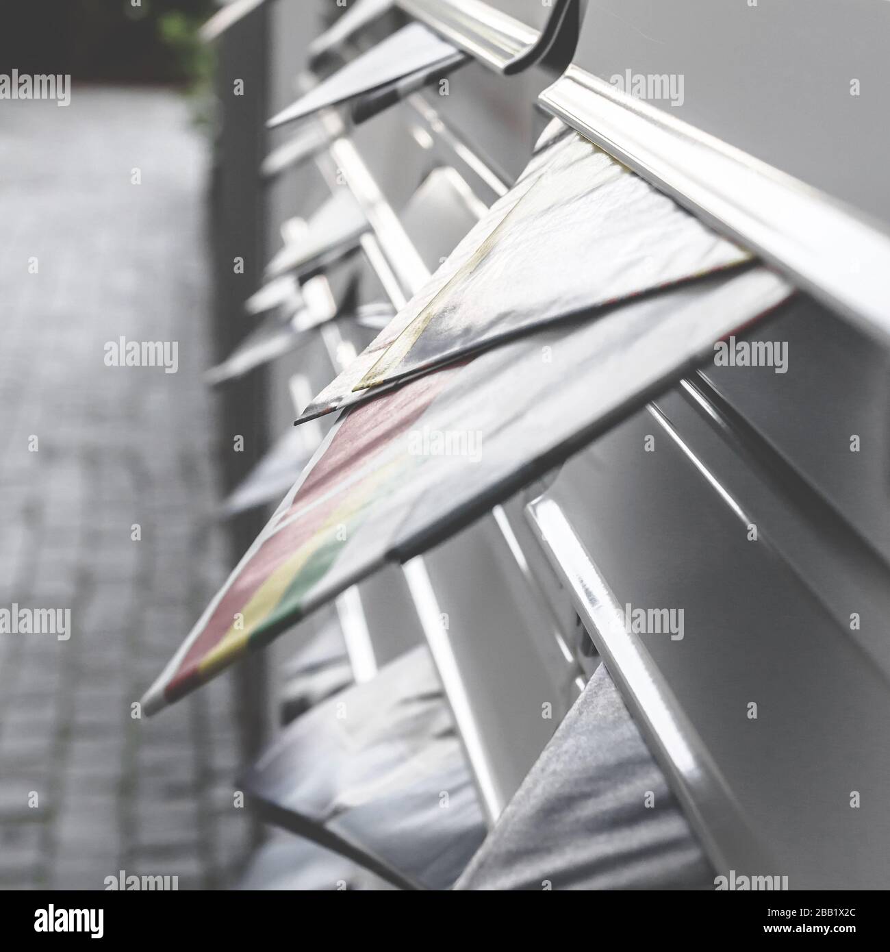 Filled letterboxes. Modern mailboxes filled of leaflets. Business and advertising concepts. Shallow depth of field. Stock Photo