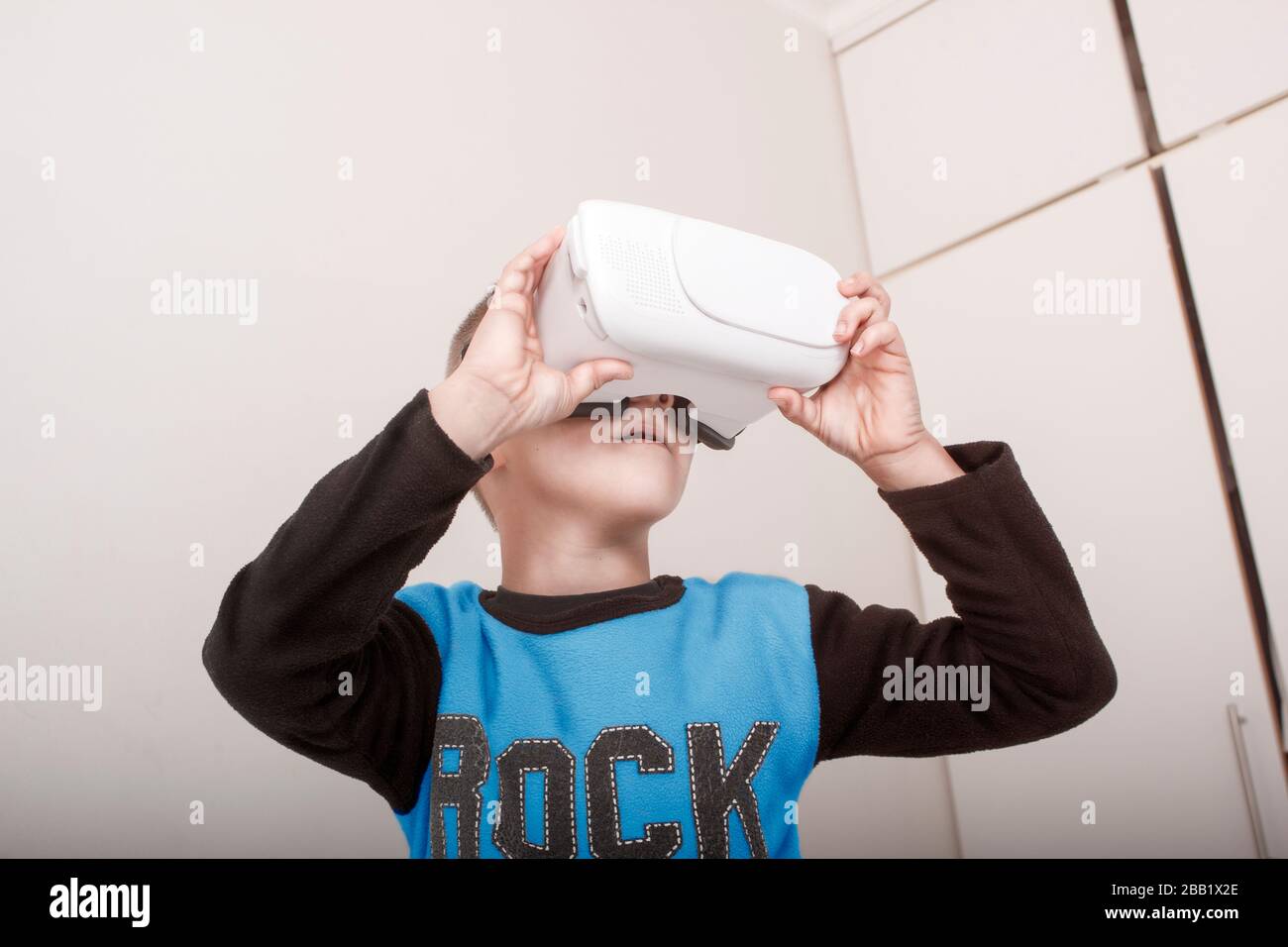 A young boy with VR (Virtual Reality) Goggles or Glasses Stock Photo