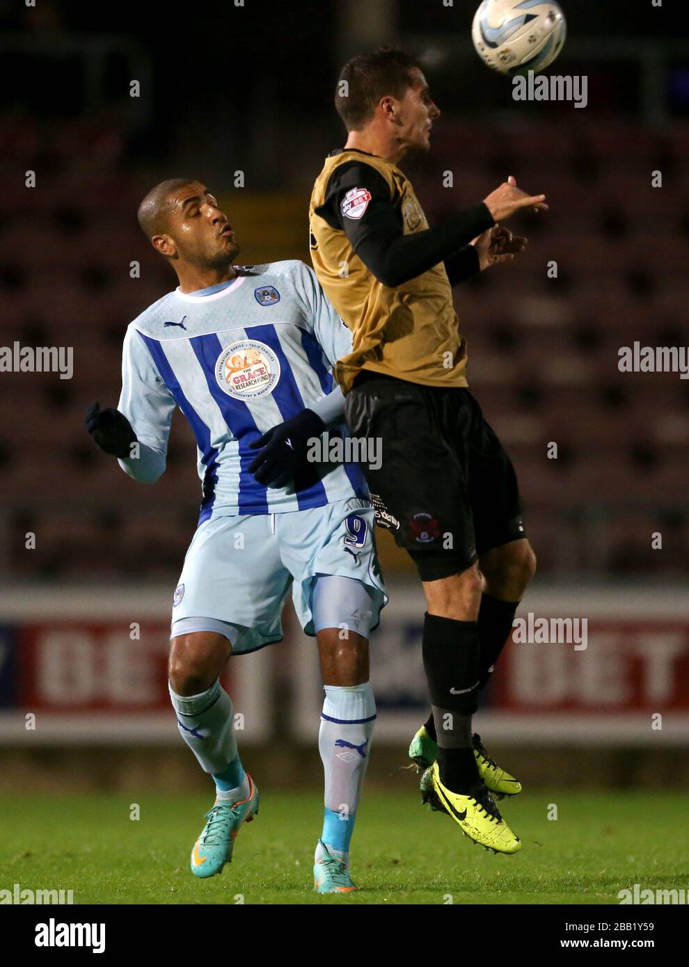 Coventry City's Leon Clarke and Leyton Orient's Dean Cox (right) battle for the ball in the air Stock Photo
