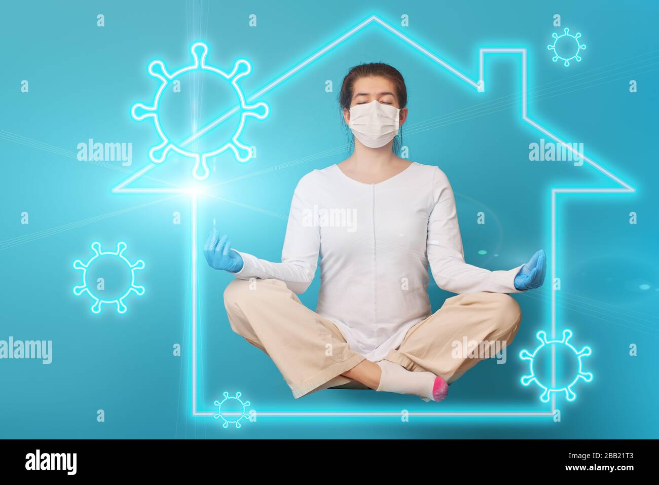 Woman levitates and relaxing in lotus pose inside symbol of house that protects her from viruses. Concept of staying at home, quarantine. Prevention m Stock Photo
