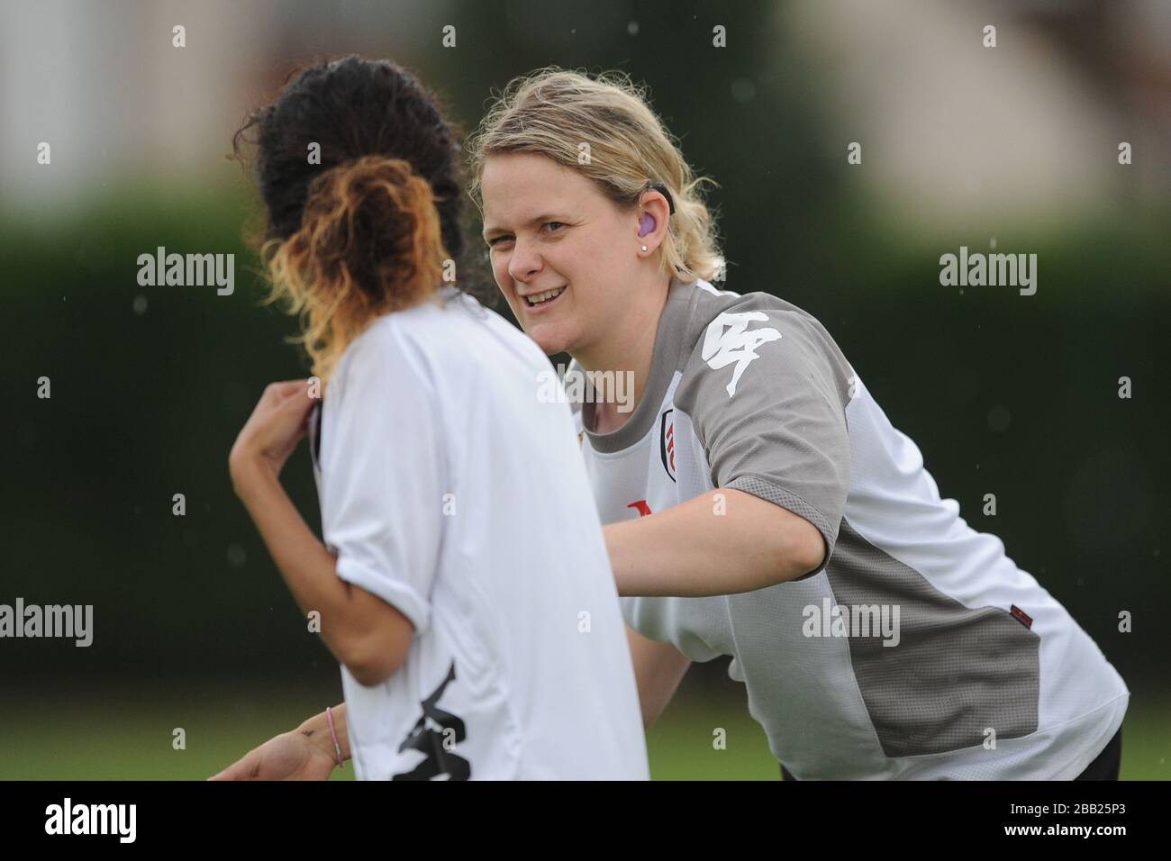 Fulham Ladies DFC coach Roanna Simmons (r) gives instructions to Pembe Alp Stock Photo