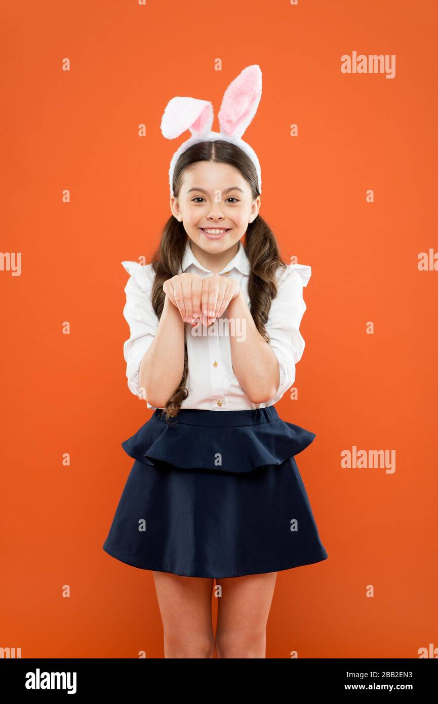 small girl wearing bunny ears on Easter day. Happy child in costume. Easter bunny  rabbit with ears. Kid on Easter egg hunt. teen kid in rabbit costume having  fun. happy easter Stock