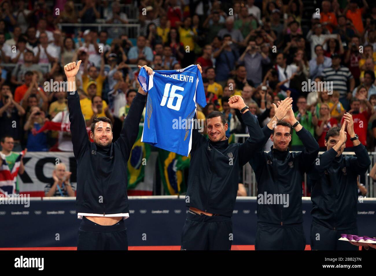 Italy's Cristian Savani (left) and Lugi Mastrangelo hold up a shirt for a team mate that sadly died during a game as the receive their Bronze Medals in the Men's Volleyball at London's Earl Court during the final day of the London 2012 Olympics. Stock Photo