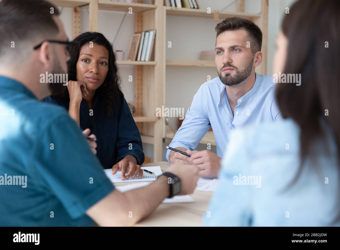 Multiracial businesspeople talk discuss ideas at briefing Stock Photo