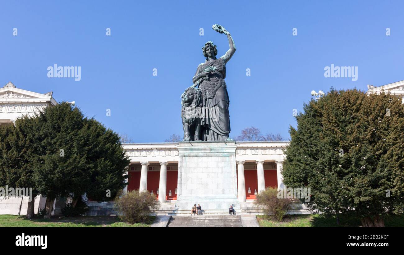 Bavaria Statue with Ruhmeshalle (hall of fame) in the background. Located at Theresienwiese. Landmark and popular tourist destination. Stock Photo