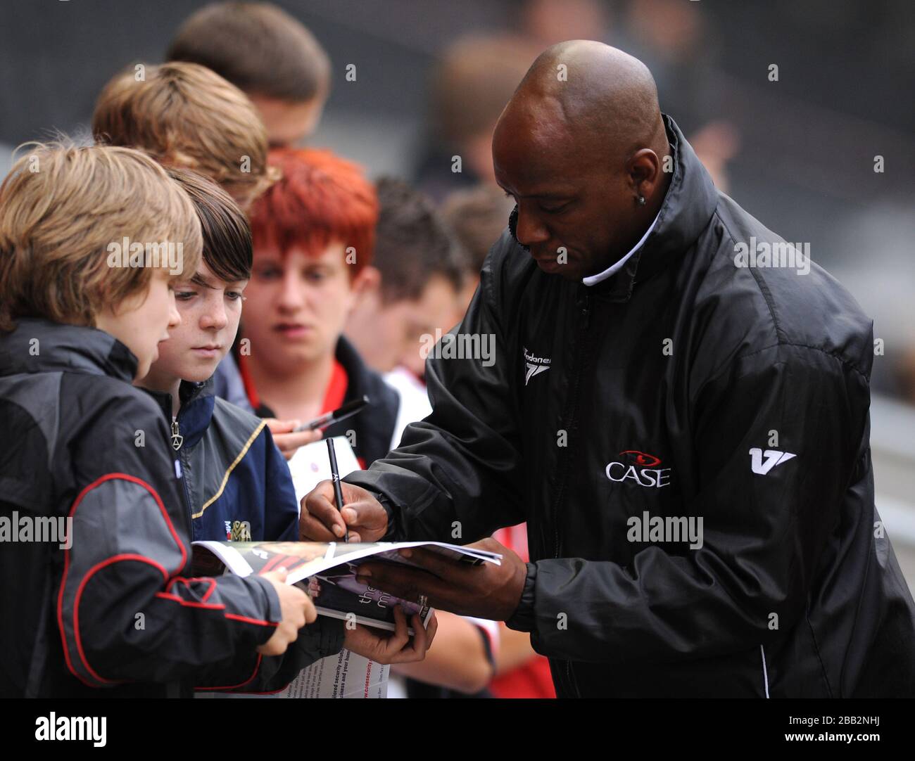 Milton Keynes Dons' First team Coach Ian Wright signs autographs for