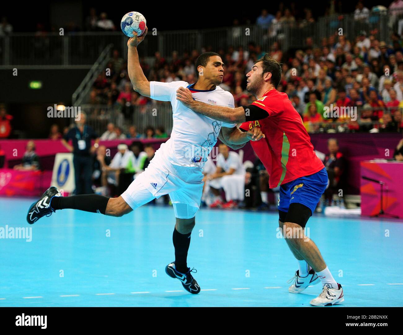 France's Daniel Narcisse (left) and Spain's Reixach Canellas during the Handball Men's Quarterfinal match at the Basketball Arena, Olympic Park. London Stock Photo