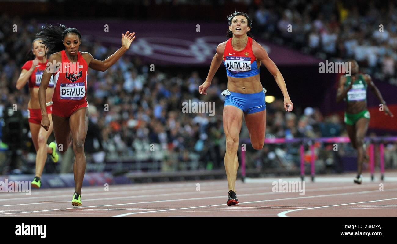 Russia's Natalya Antyukh (right) on her way to winning the gold medal during the Women's 400m Hurdles with USA's Lashinda Demus (left) taking silver, on the 12th day of the London 2012 Olympics. Stock Photo