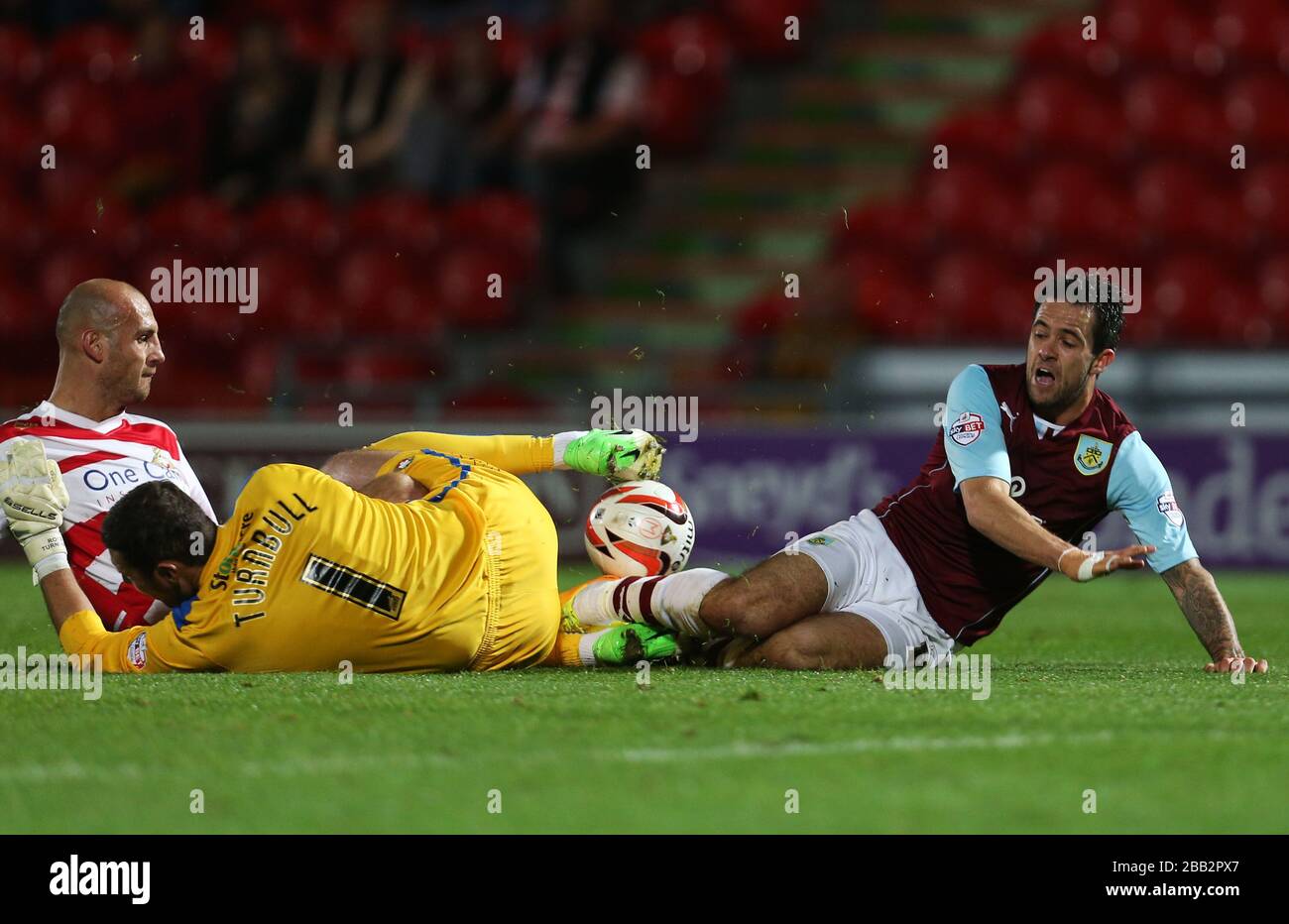 Doncaster Rovers' Ross Turnbull and Rob Jones tackle Burnley's Danny Ings. Stock Photo