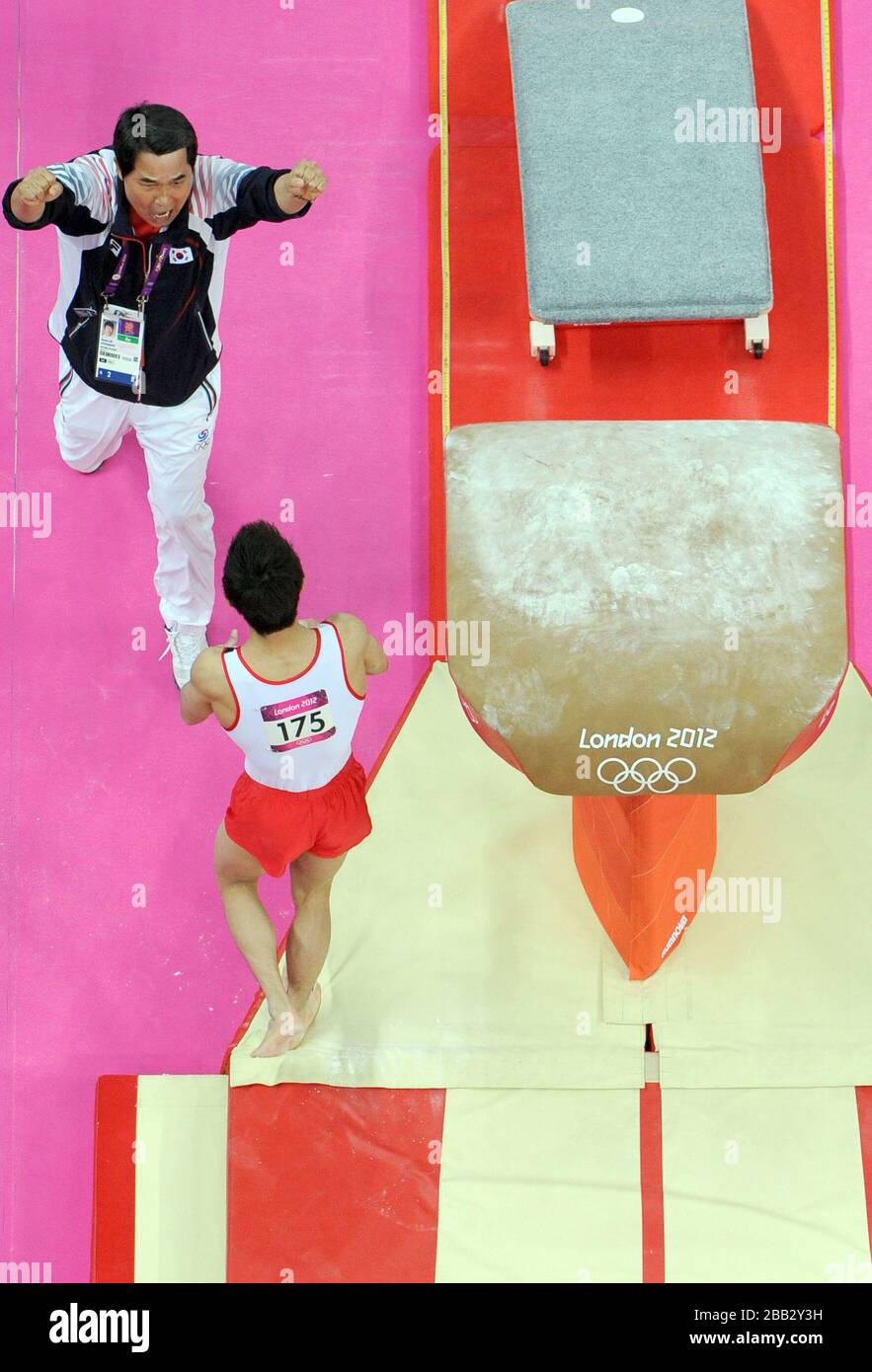 Korea's Seon Hak Yang celebrates with his coach after winning the gold