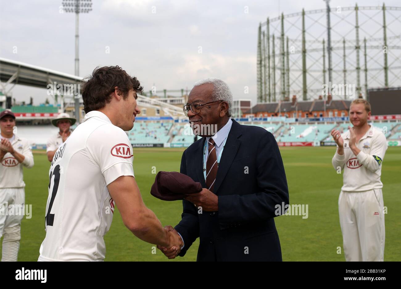 Surrey Zafar Ansari (left) is presented with his 2nd XI cap by club president Sir Trevor McDonald (right) Stock Photo