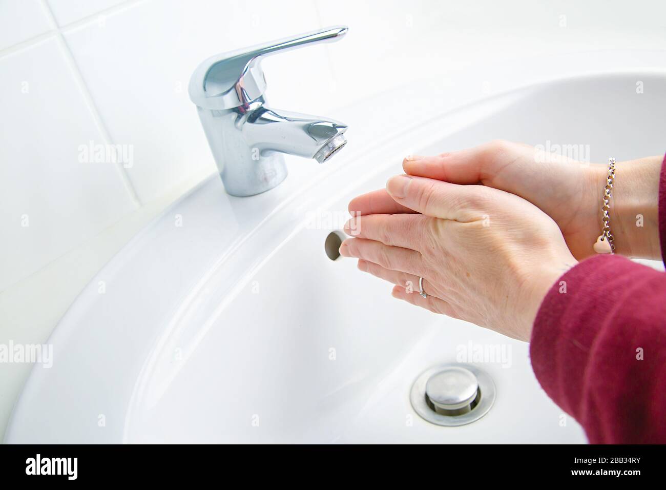 Woman cleaning and washing hands with soap in her bathroom Stock Photo ...