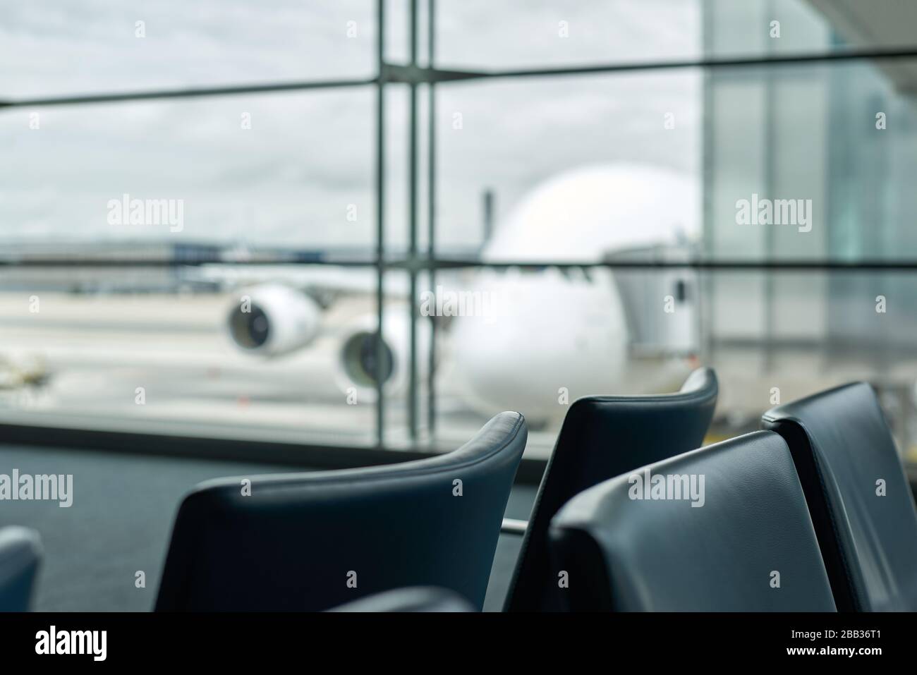 Empty airport with blurred plane and cloudy tragik sky on a background Stock Photo