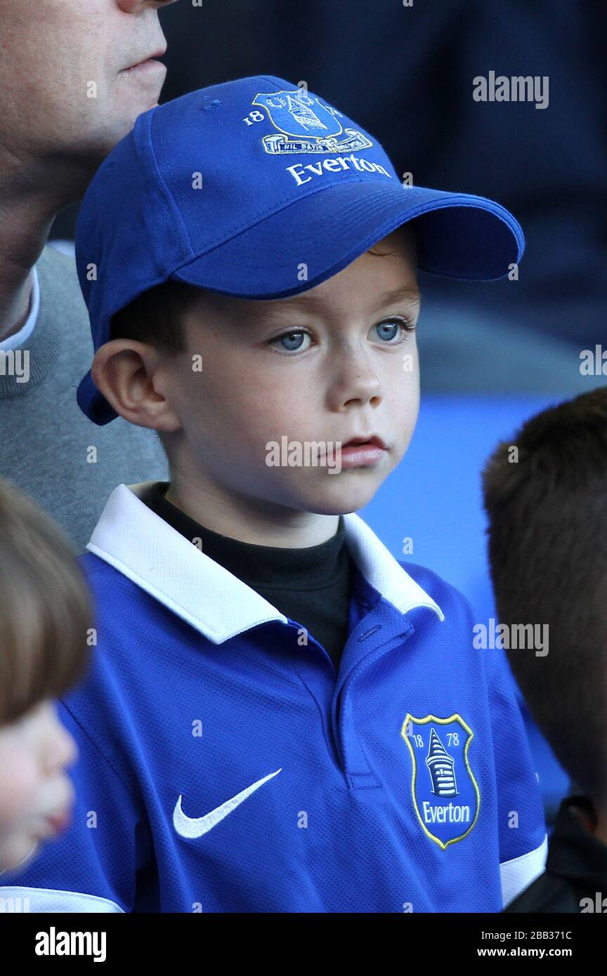 A young Everton fan in the stands Stock Photo