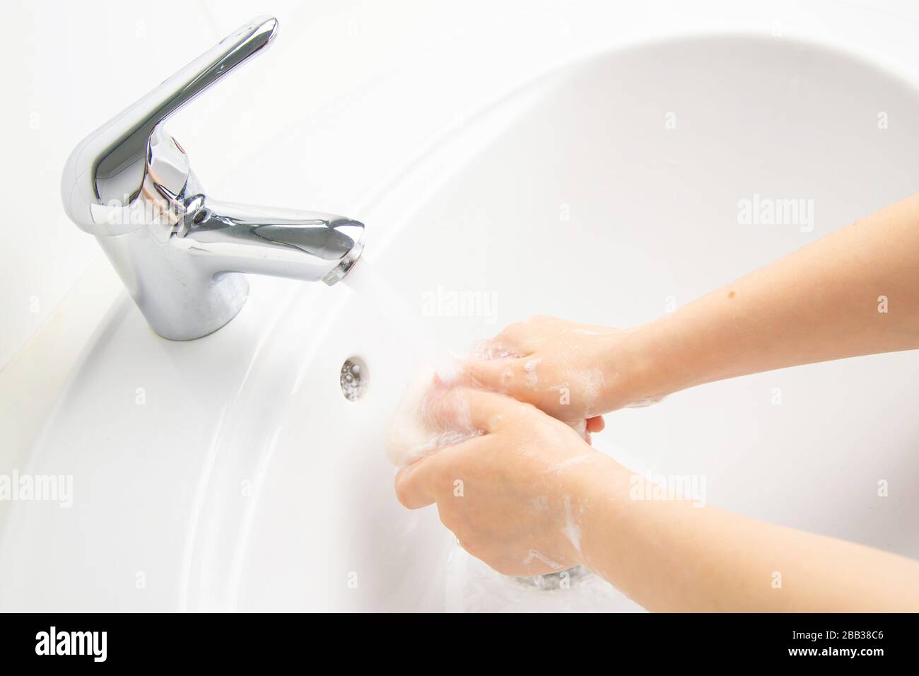 Kid cleaning and washing hands with soap in the bathroom Stock Photo ...