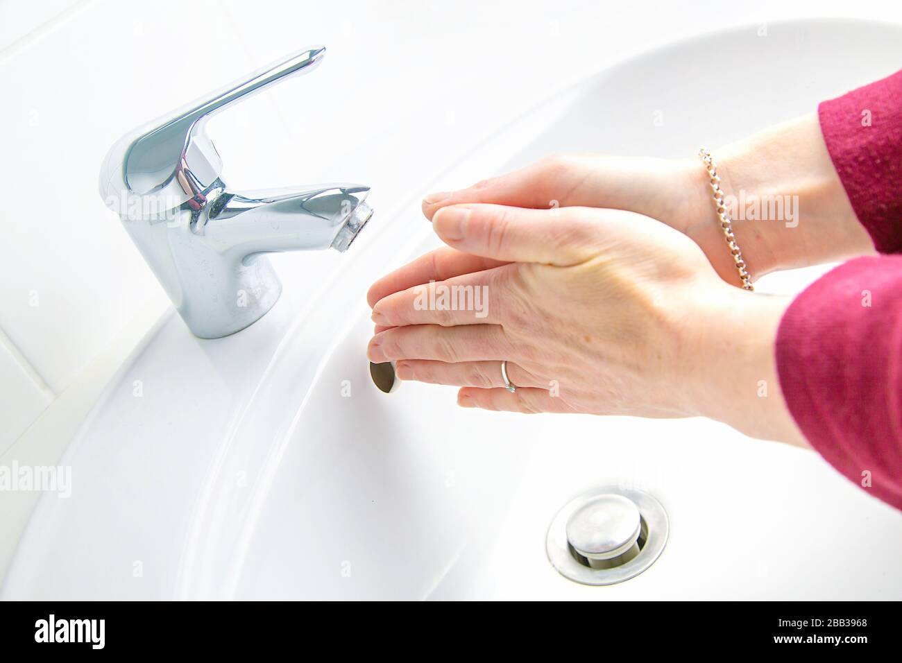 Woman cleaning and washing hands with soap in her bathroom Stock Photo ...