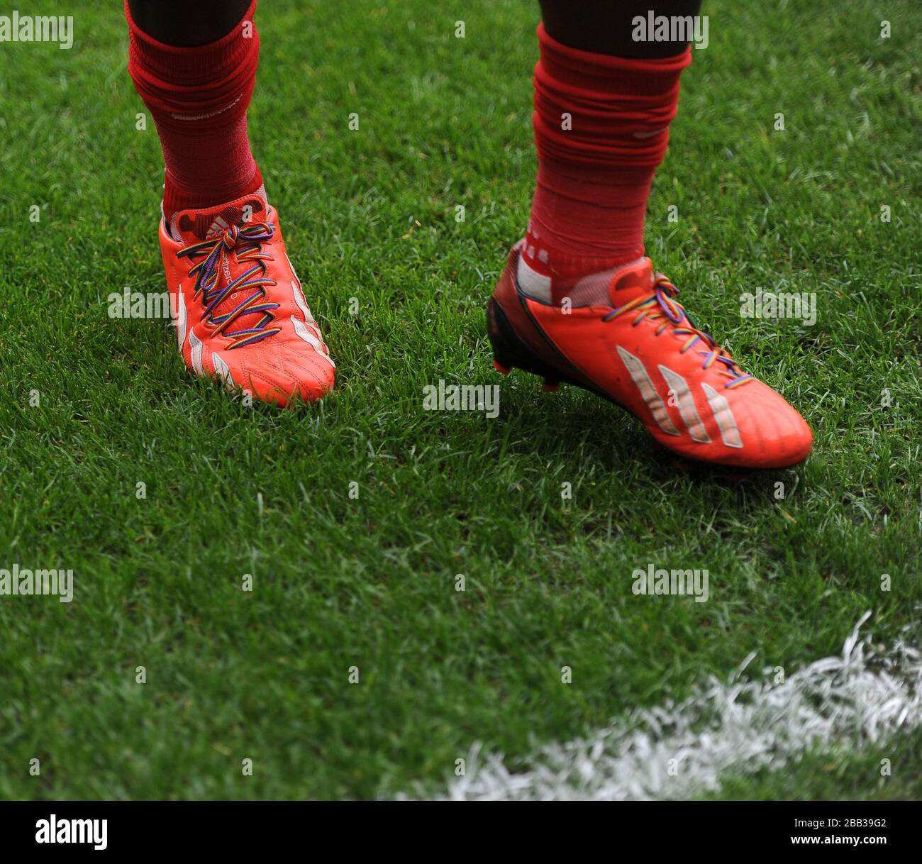 A pair of football boots with multi coloured laces hires stock