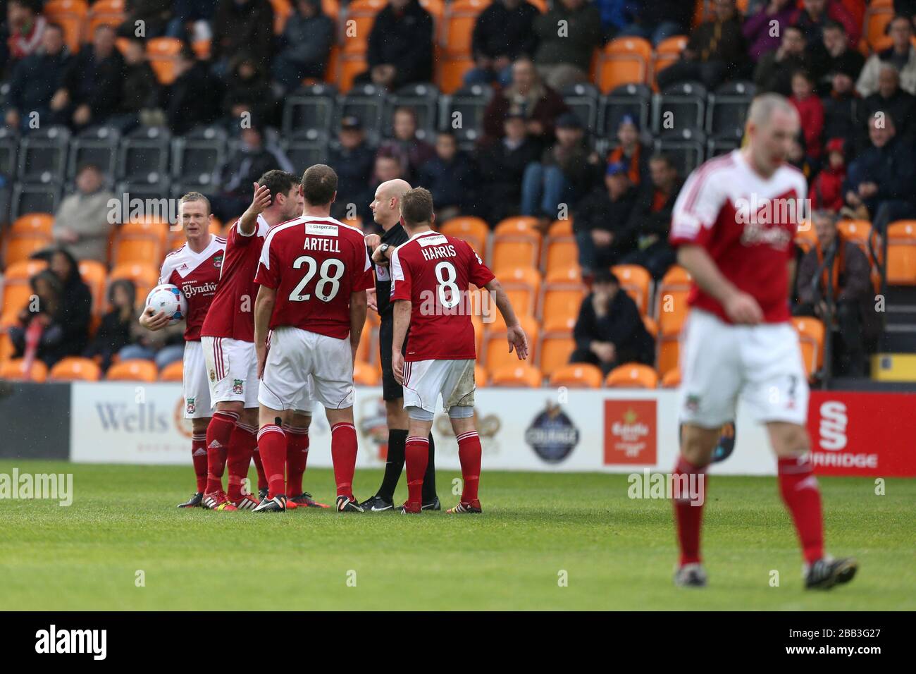 Wrexham players argue with referee Nick Kinseley as teammate Stephen