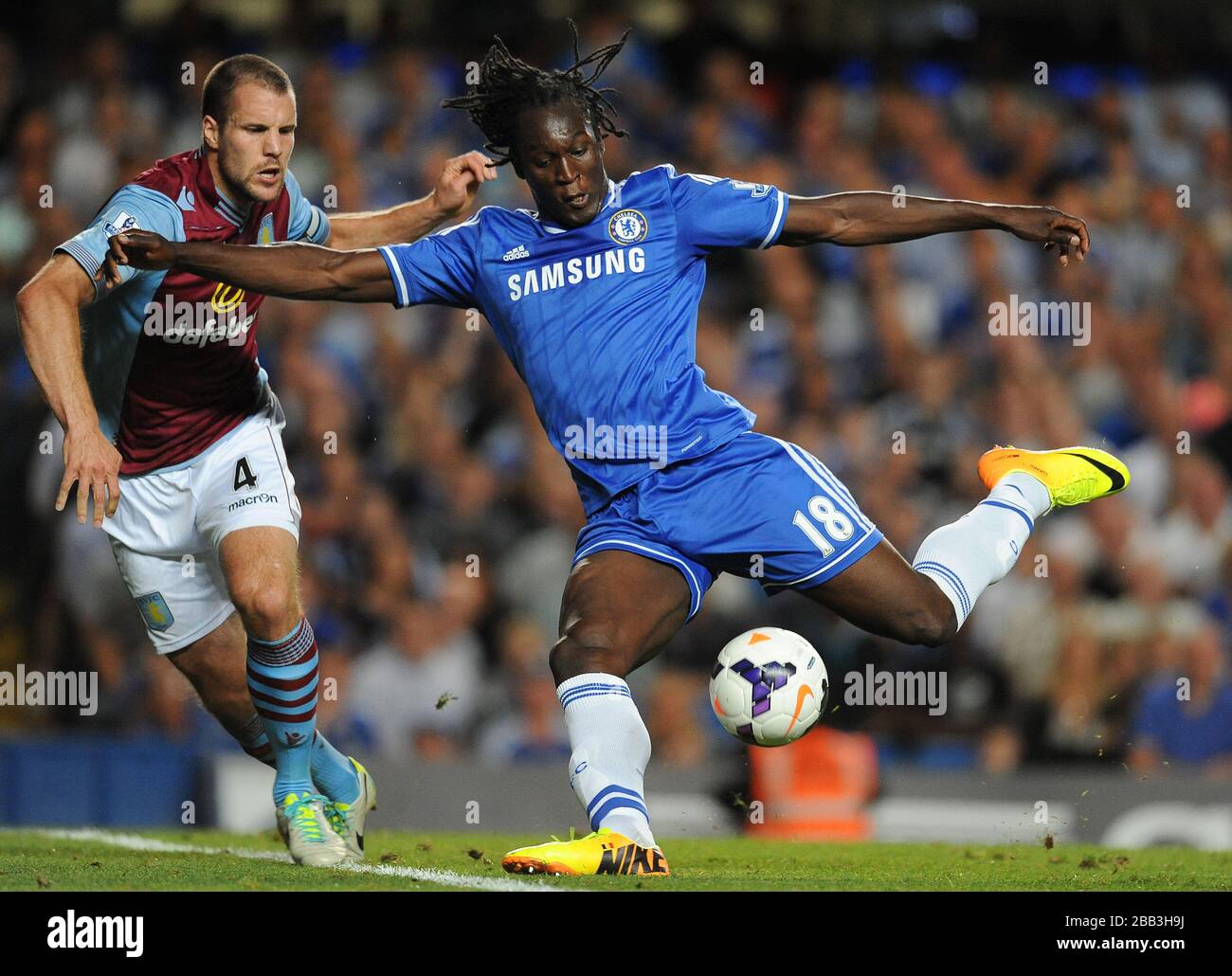 Chelsea's Romelu Lukaku (right) and Aston Villa's Ron Vlaar (left) battle for the ball. Stock Photo