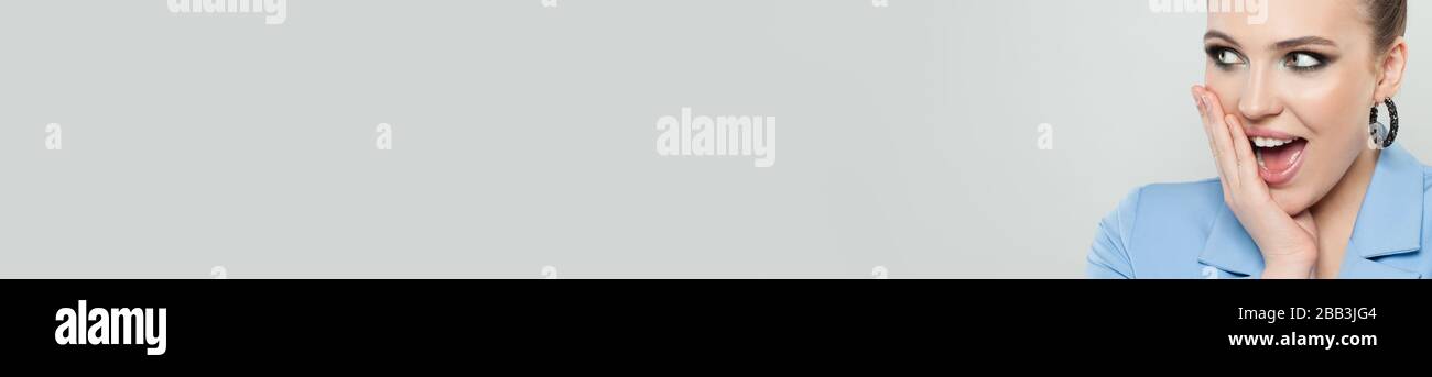 Happy surprised woman on white banner background Stock Photo - Alamy