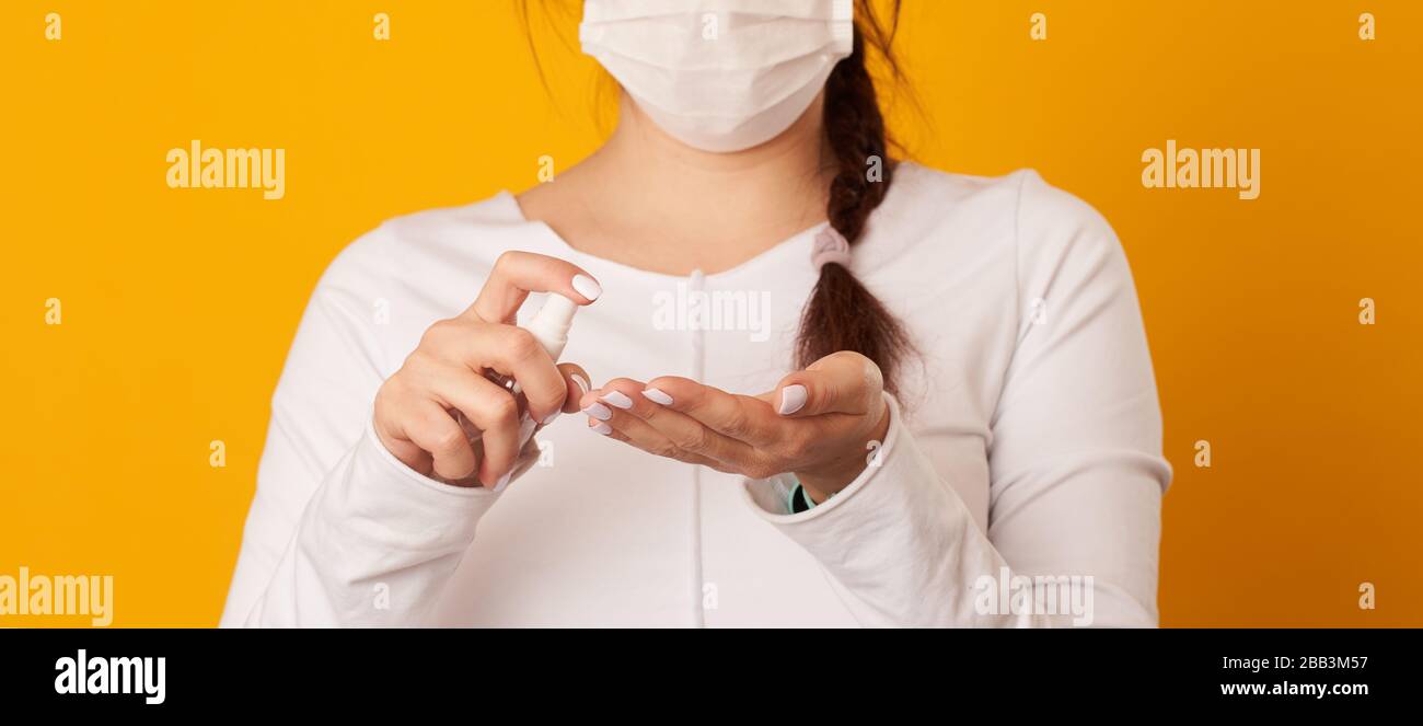 Woman is using antiseptic for hands. Concept of hygiene, protect of virus. Covid-19 Corona Prevention Measures. Stock Photo