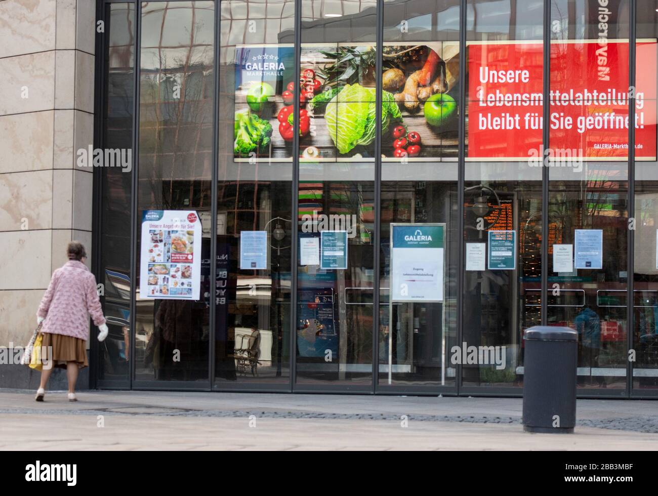 30 March 2020, North Rhine-Westphalia, Dortmund: A large LED screen in the entrance area of a Karstadt department store indicates that the food department is still open. However, the entrance is only possible via designated entrances. The department store group Galeria Karstadt Kaufhof continues to wait for government aid. The business in the department stores is largely, but not completely, at rest. Around 50 food departments of the company are still open. Photo: Bernd Thissen/dpa Stock Photo