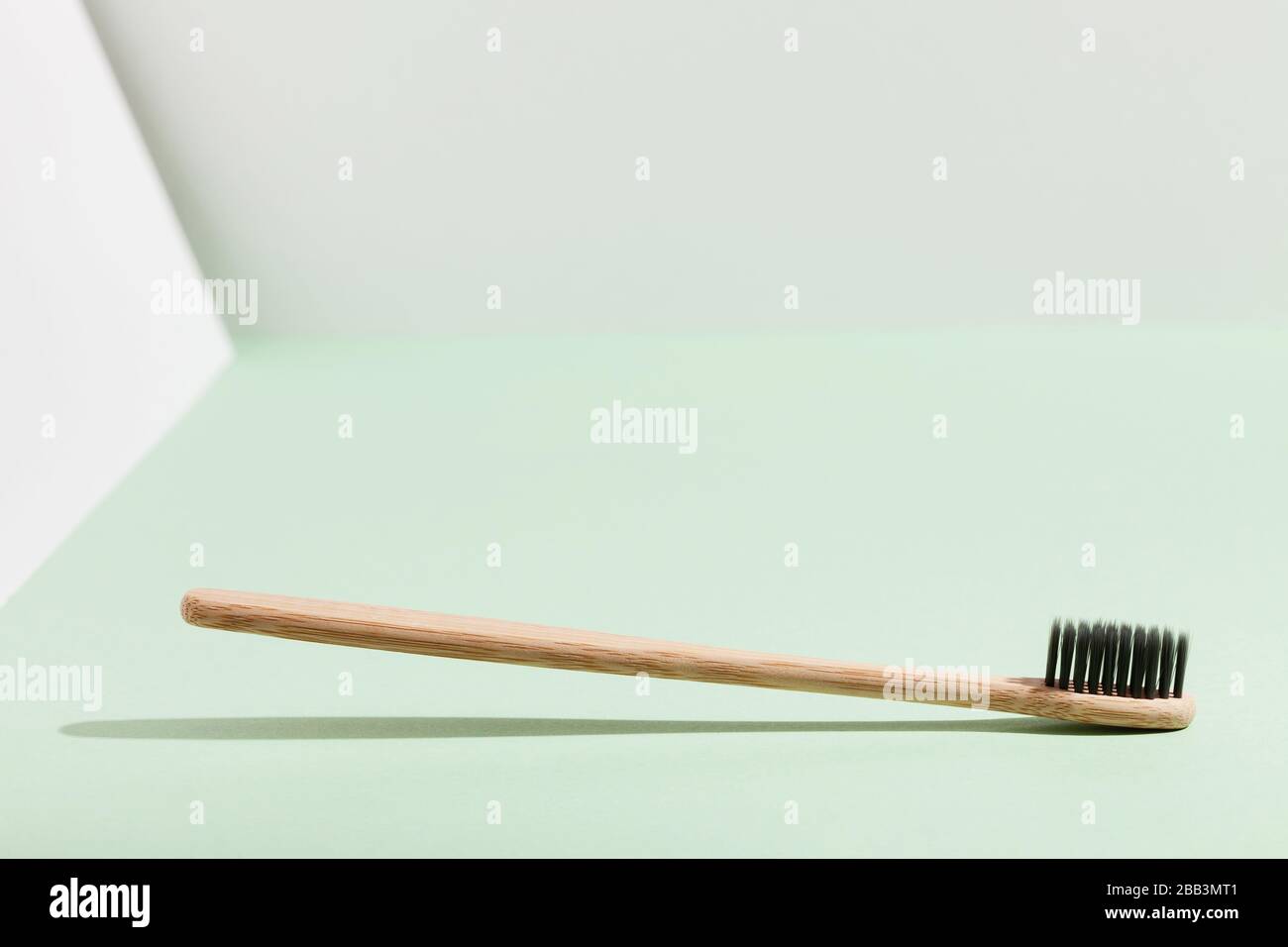 One soaring bamboo toothbrush on a mint-white volumetric background ...