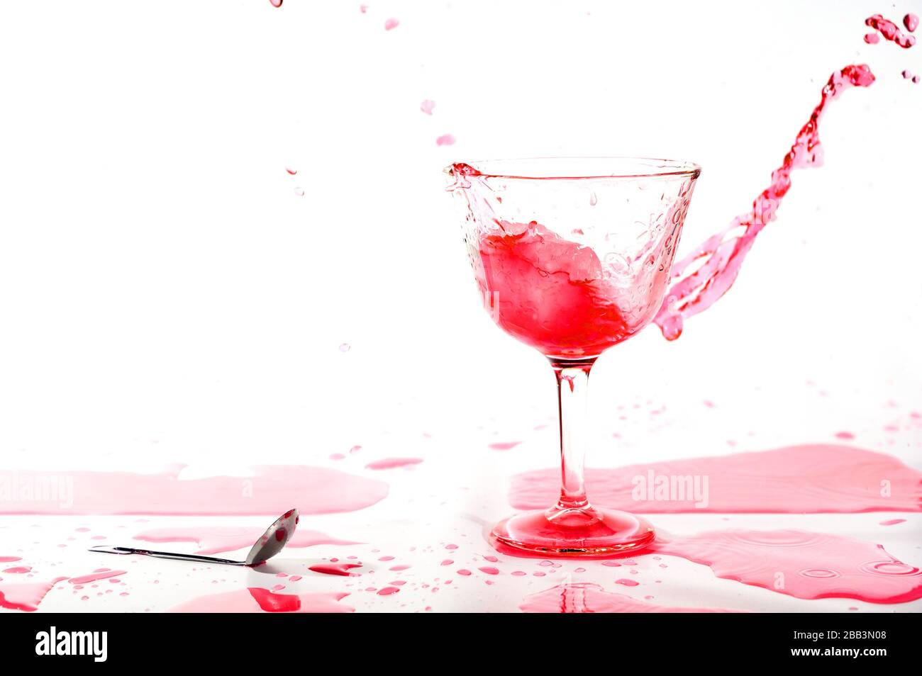 Red alcohol cocktail drink splash on white background Stock Photo Alamy