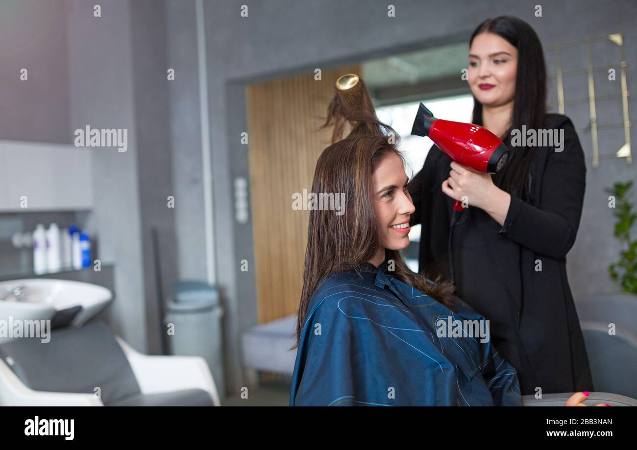 Hairdresser and client at hair salon Stock Photo - Alamy