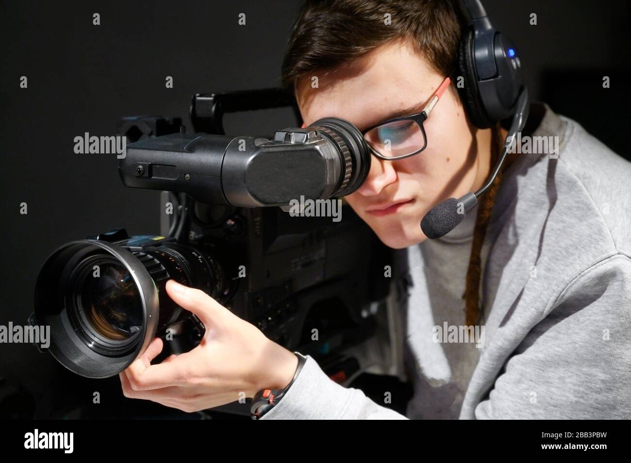 Cameraman using professional digital video camera. Stock Photo